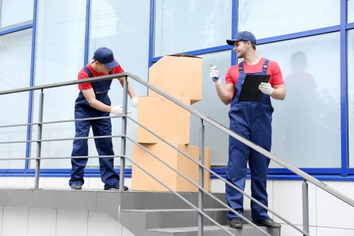 Removalists navigating access and stairs in a central London property