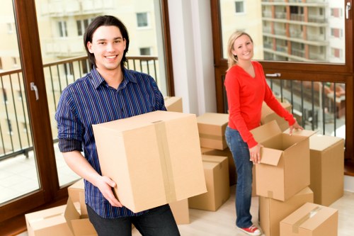 Local movers transporting furniture through a central London residential property